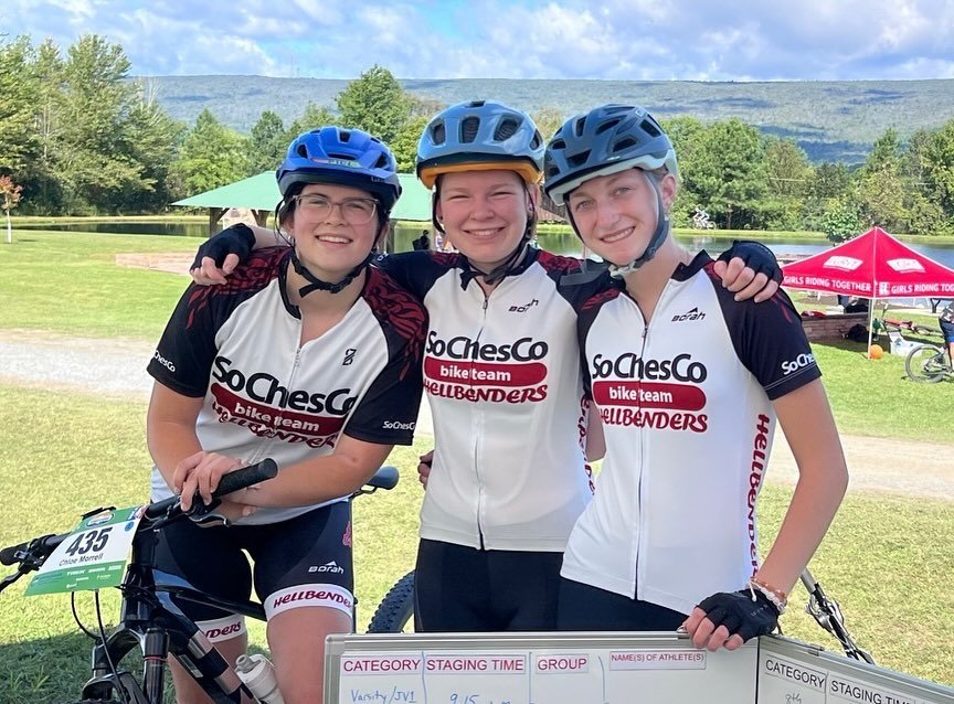 Three SoChesco Hellbenders riders smiling together at an event